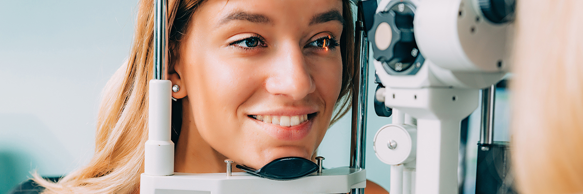 A women having her eyes studied by an optician